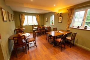 Dining room at The Gate Pub with wooden tables and chairs