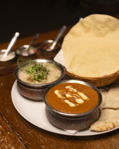 Curry with raita, poppadoms and naan at The Gate Pub